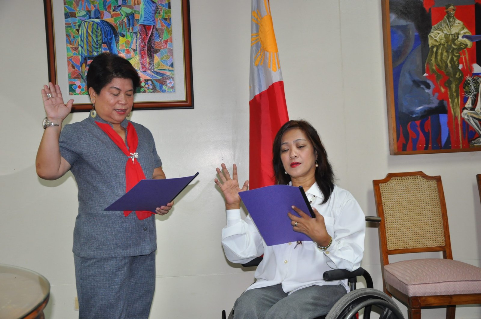 DSWD Secretary Corazon Juliano Soliman administers the oath taking of Ms. Carmen Reyes Zubiaga as the new Acting Executive Director of the National Council on Disability Affairs.