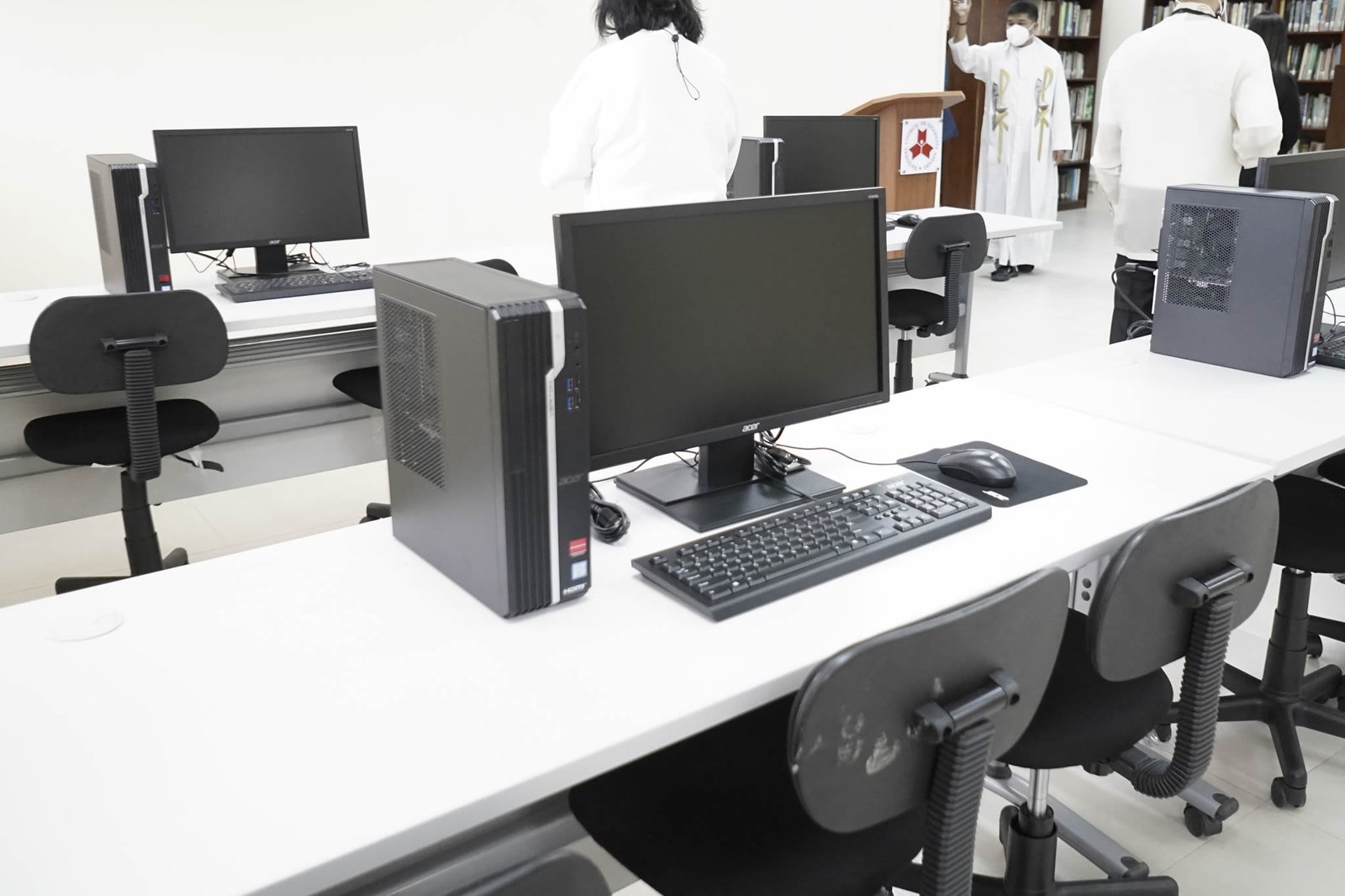Modern desktop computers are being blessed by a Catholic priest
