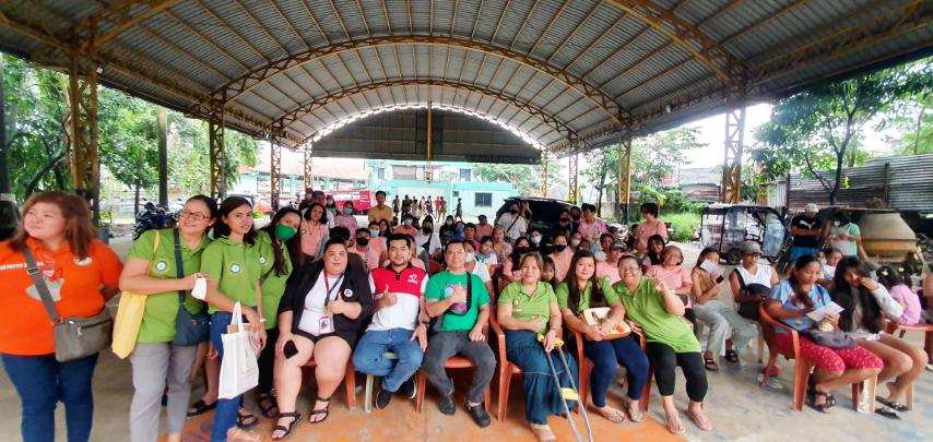 Recipients of free hearing assessment pose together with Sir Don